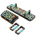 A foldable push-up board shown in two positions on a white surface, with colorful printed exercise path graphics across the metal surface. 